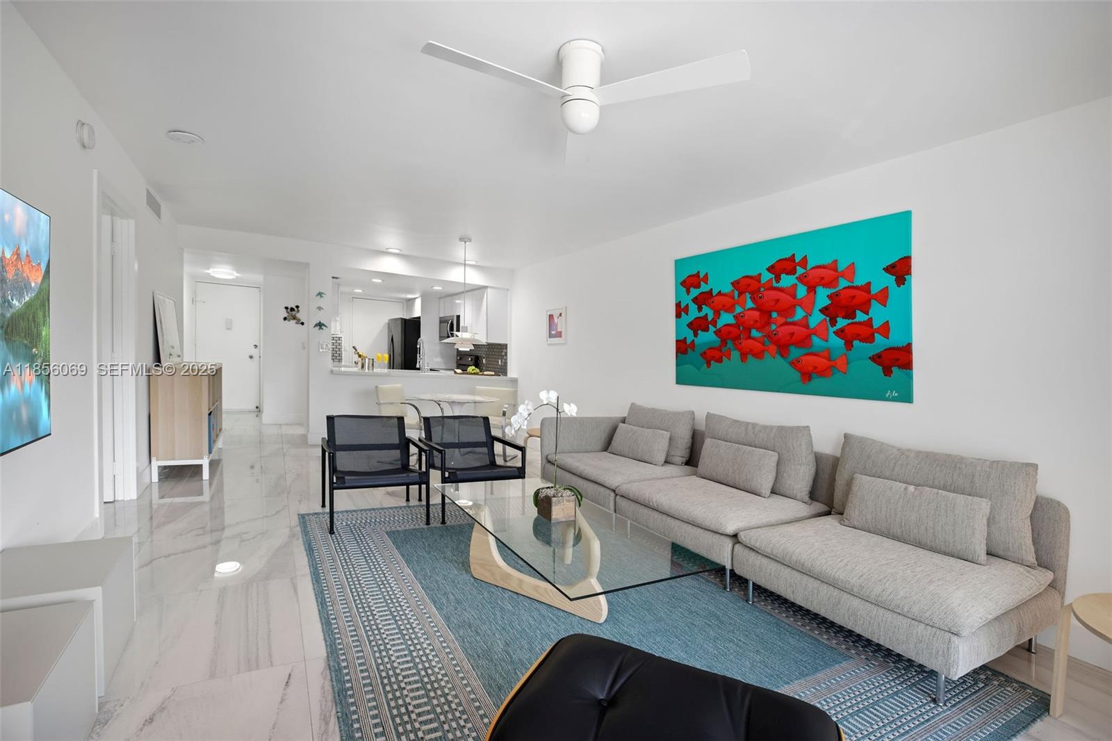 1450 Lincoln Road, Unit 403 Miami Beach, FL 33139 - Photo 18 of 29 a living room with furniture a flat screen tv and kitchen view