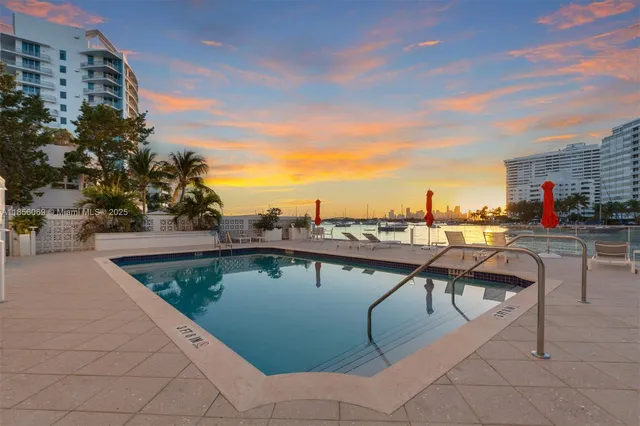 a view of outdoor space with swimming pool and seating