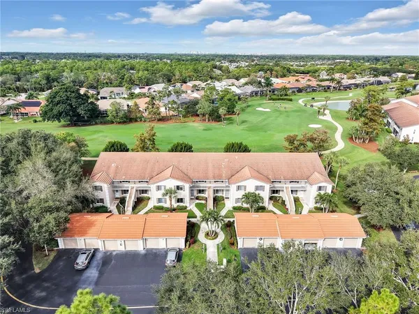 an aerial view of a house with garden space and ocean view