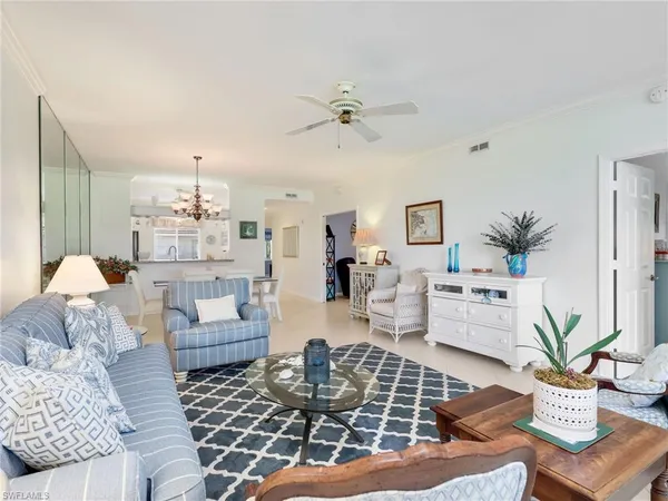 a living room with furniture and a chandelier