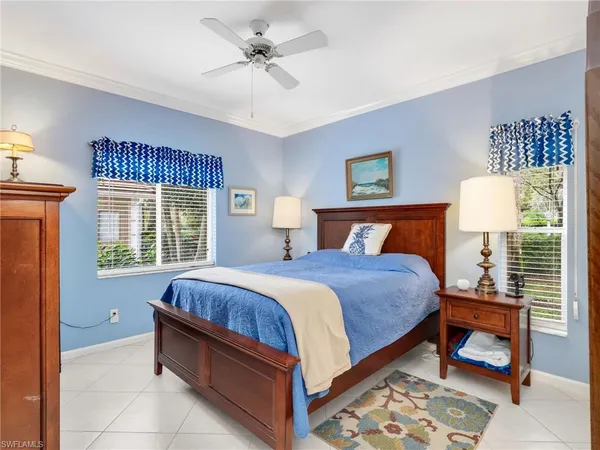 a bed room with a bed and a chair