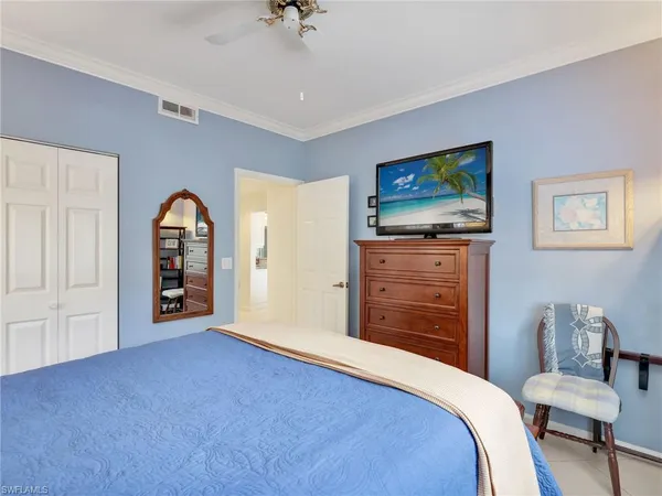 a bedroom with furniture and a flat screen tv