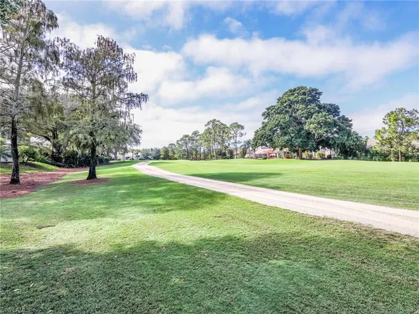 a view of a golf course with a big yard