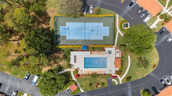 an aerial view of a house with a garden and lake view