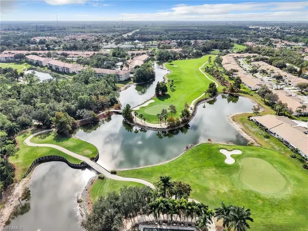 an aerial view of a house with a garden lake view and mountain view in back