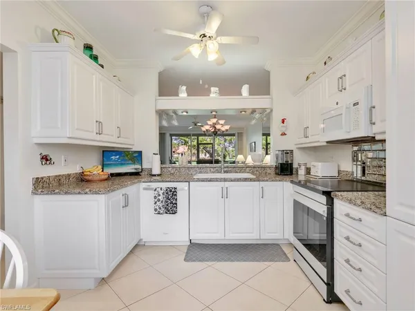 a kitchen with stainless steel appliances granite countertop a sink and cabinets