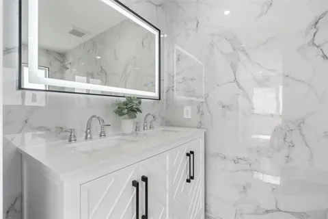 a white toilet sitting next to a shower