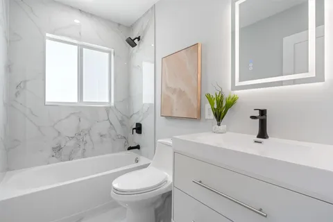 an empty room with a window and a ceiling fan