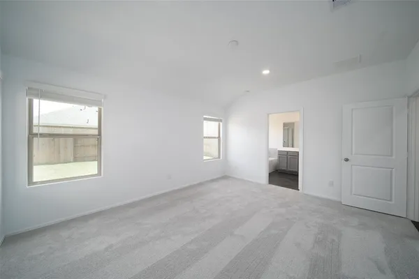 an empty room with windows and closet