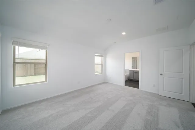 an empty room with windows and closet