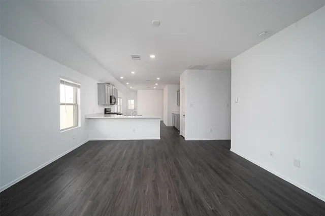 a view of kitchen with wooden floor and windows