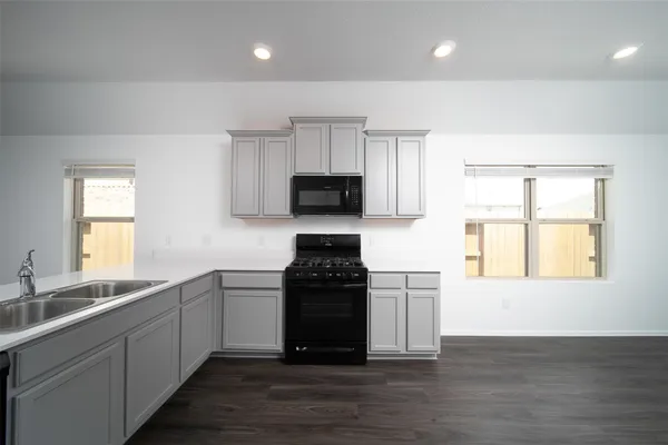 a kitchen with a sink and a stove top oven