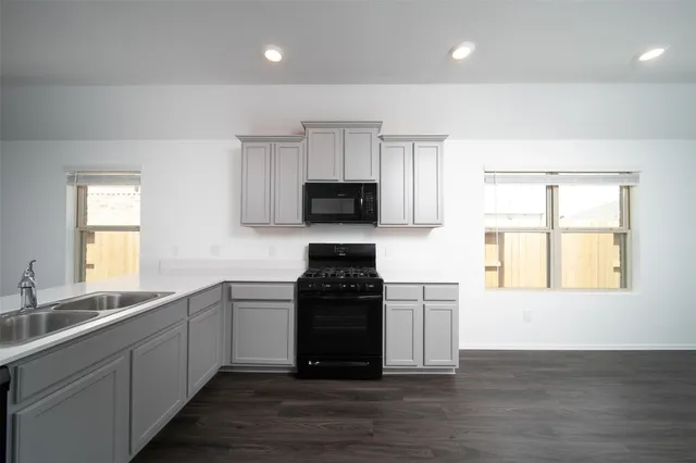 a kitchen with a sink and a stove top oven
