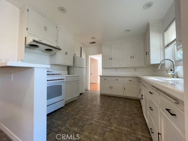 471 Woodward Boulevard Pasadena, CA 91107 - Photo 2 of 30 a kitchen with cabinets stainless steel appliances and sink