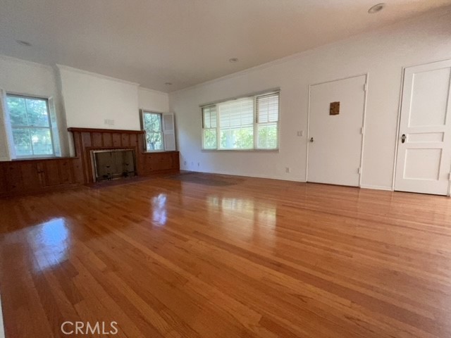 471 Woodward Boulevard Pasadena, CA 91107 - Photo 3 of 30 an empty room with wooden floor and windows