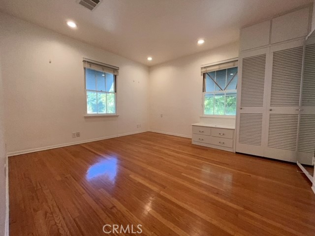 471 Woodward Boulevard Pasadena, CA 91107 - Photo 5 of 30 an empty room with wooden floor and windows