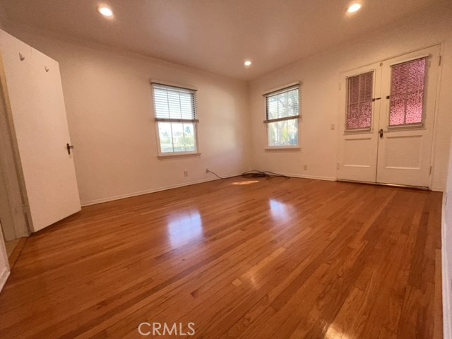 471 Woodward Boulevard Pasadena, CA 91107 - Photo 7 of 30 an empty room with wooden floor and windows