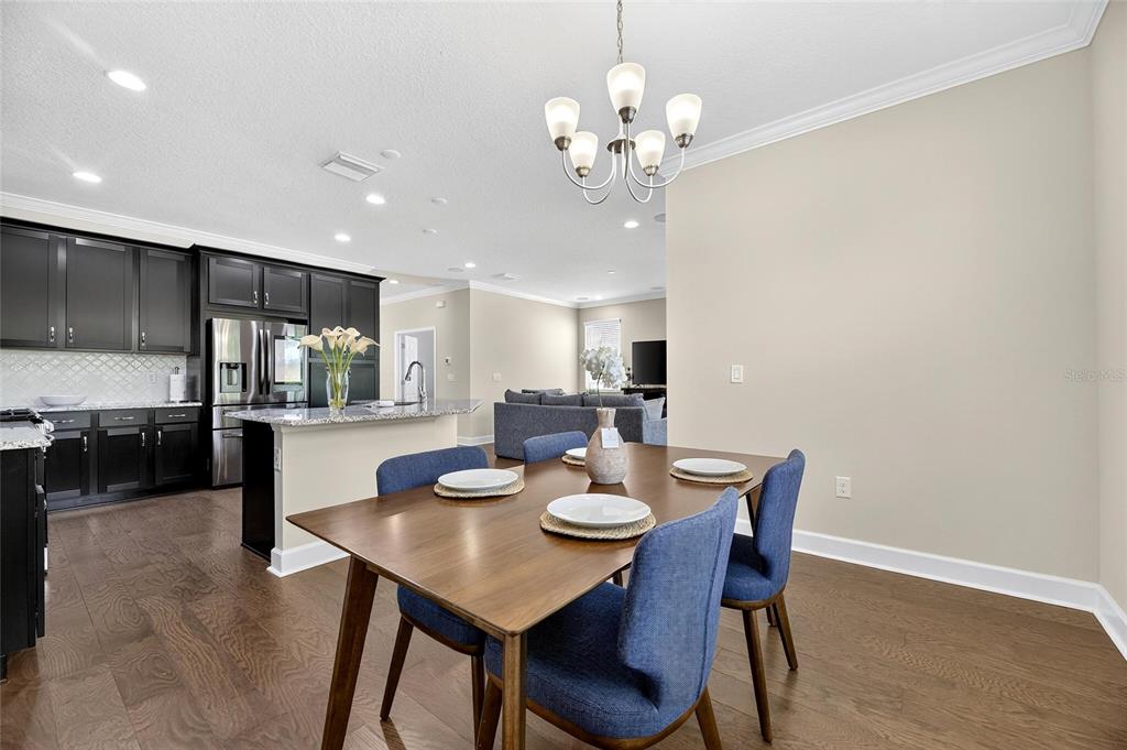 5534 Silver Sun Drive Apollo Beach, FL 33572 - Photo 19 of 76 a view of a dining room with furniture and wooden floor