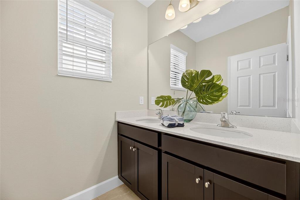 5534 Silver Sun Drive Apollo Beach, FL 33572 - Photo 42 of 76 a bathroom with a granite countertop sink a mirror and a window