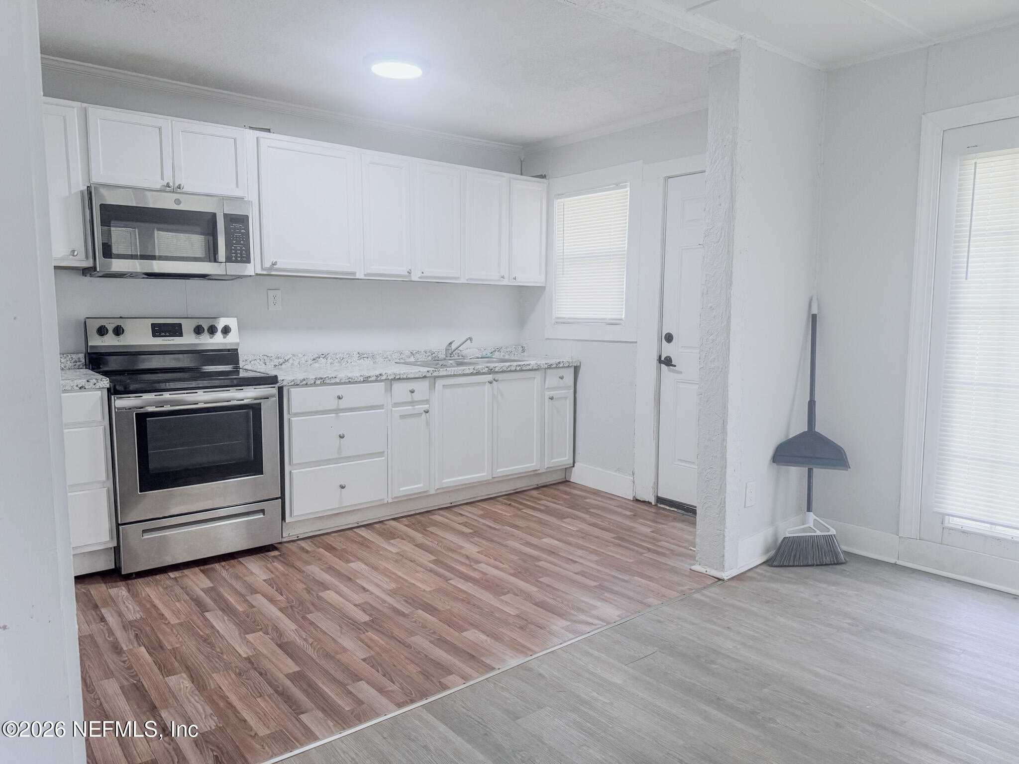 10728 Old Kings Road Jacksonville, FL 32219 - Photo 4 of 21 a kitchen with stainless steel appliances granite countertop a stove a sink and a microwave