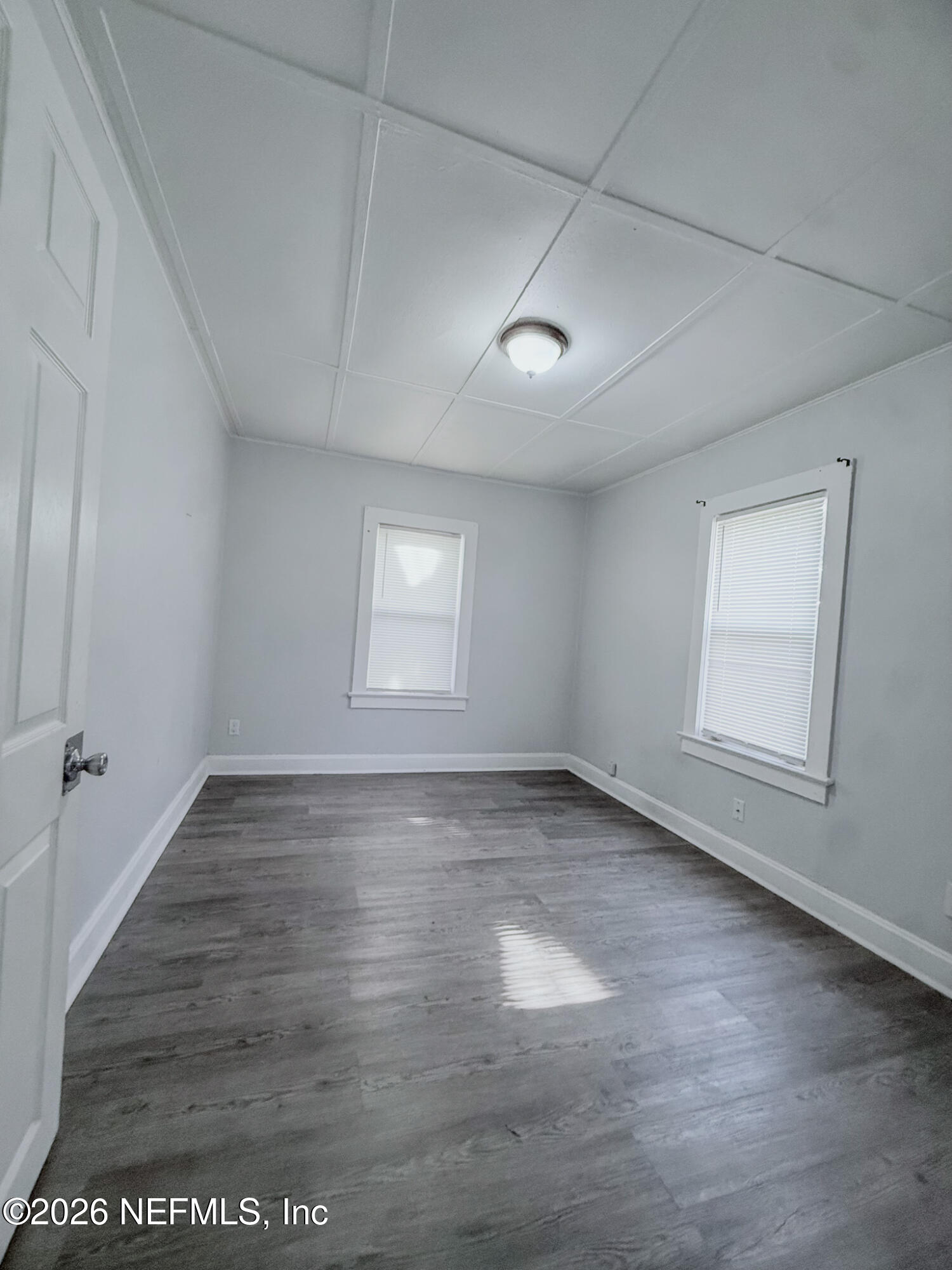 10728 Old Kings Road Jacksonville, FL 32219 - Photo 7 of 21 an empty room with wooden floor and windows