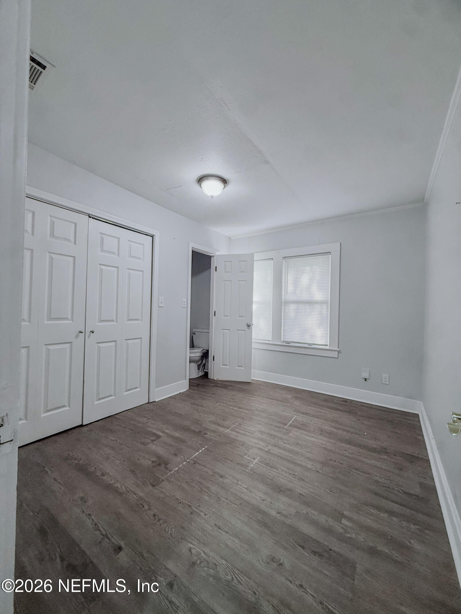 10728 Old Kings Road Jacksonville, FL 32219 - Photo 8 of 21 an empty room with wooden floor and windows