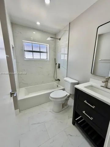 a bathroom with a toilet a sink and bathtub