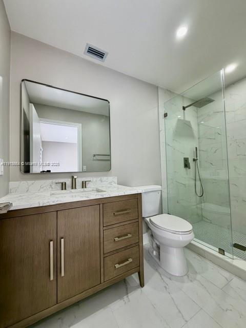 9108 Northwest 190th Terrace Hialeah, FL 33018 - Photo 5 of 10 a bathroom with a double vanity sink toilet and shower