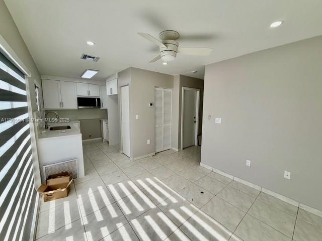 9108 Northwest 190th Terrace Hialeah, FL 33018 - Photo 7 of 10 a view of kitchen with sink refrigerator and microwave