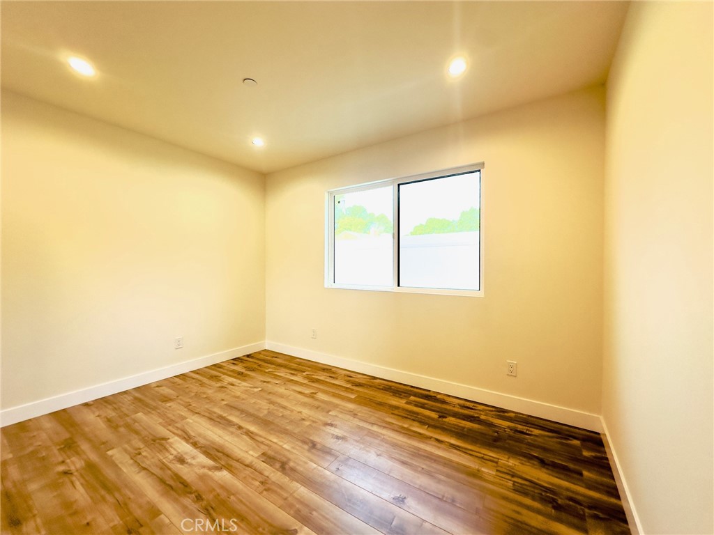 15952 Cohasset Street Van Nuys, CA 91406 - Photo 11 of 11 an empty room with wooden floor and windows