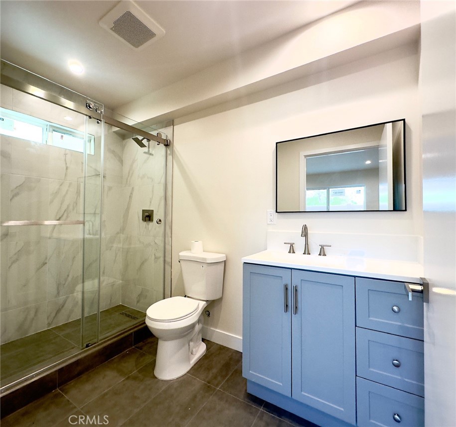 15952 Cohasset Street Van Nuys, CA 91406 - Photo 9 of 11 a bathroom with a toilet sink and mirror