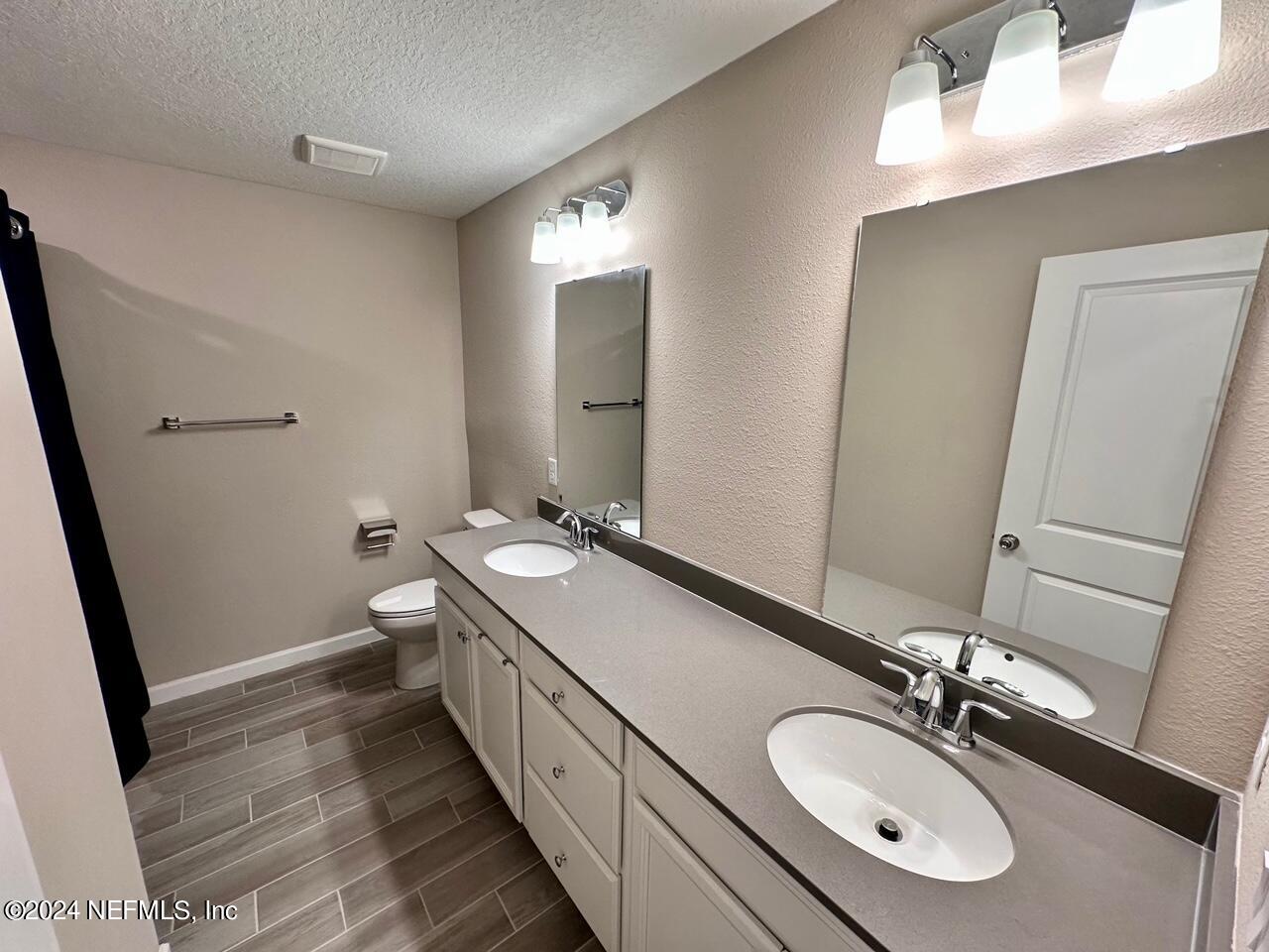 435 Boracay Circle St. Johns, FL 32259 - Photo 11 of 31 a bathroom with a double vanity sink and a mirror