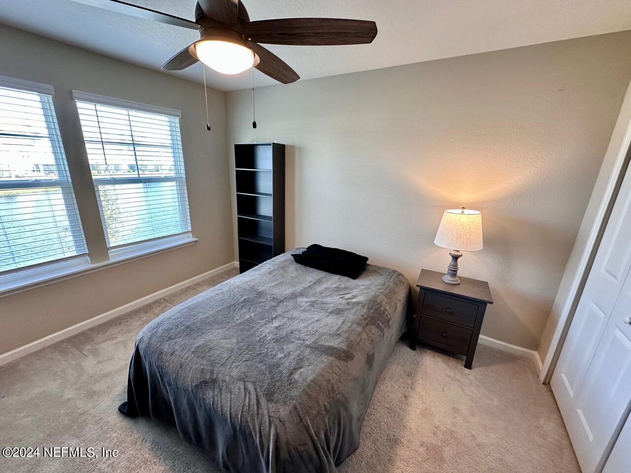 435 Boracay Circle St. Johns, FL 32259 - Photo 13 of 31 a bedroom with a bed and a chandelier