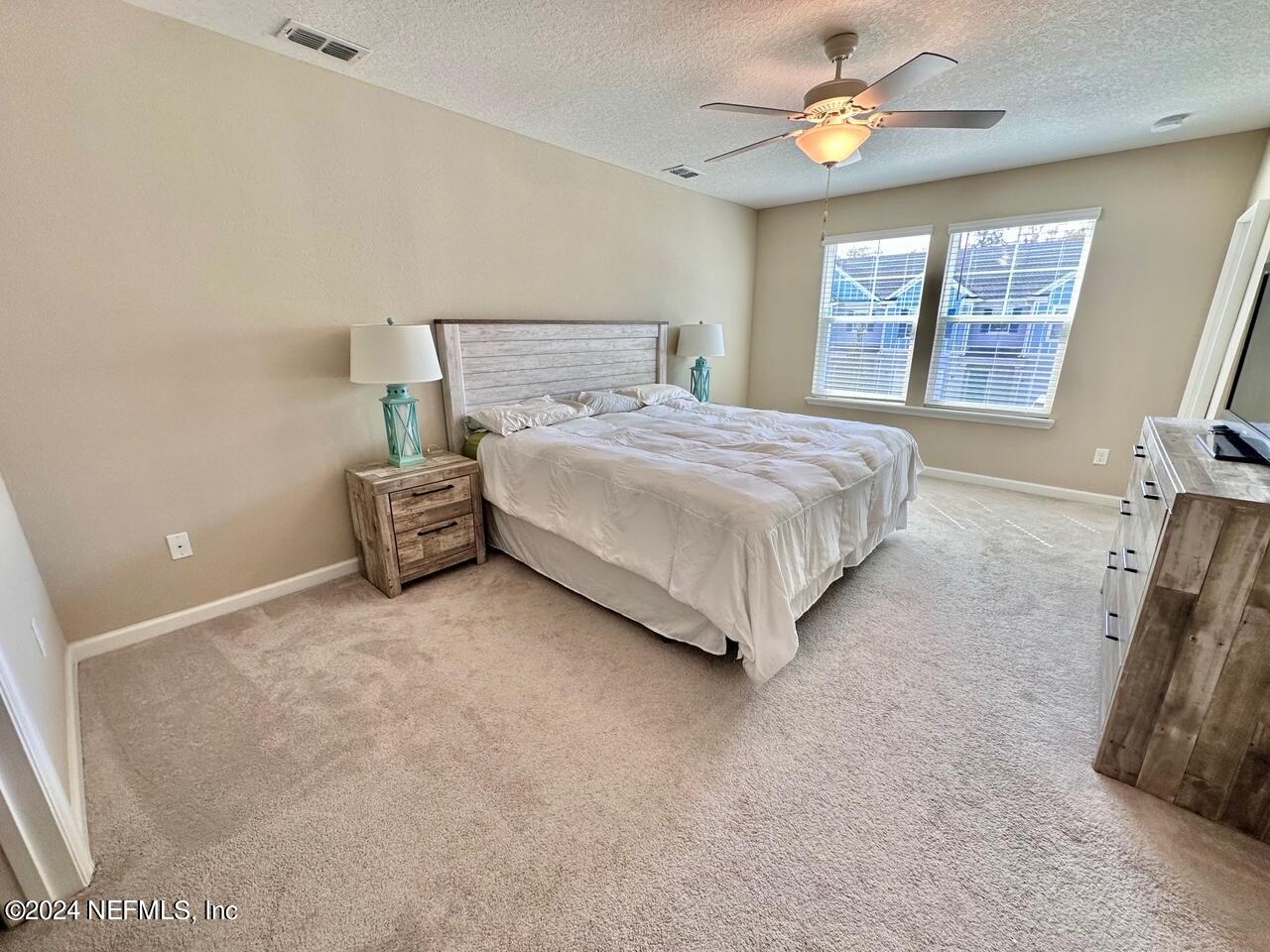 435 Boracay Circle St. Johns, FL 32259 - Photo 15 of 31 a spacious bedroom with a bed and a large window