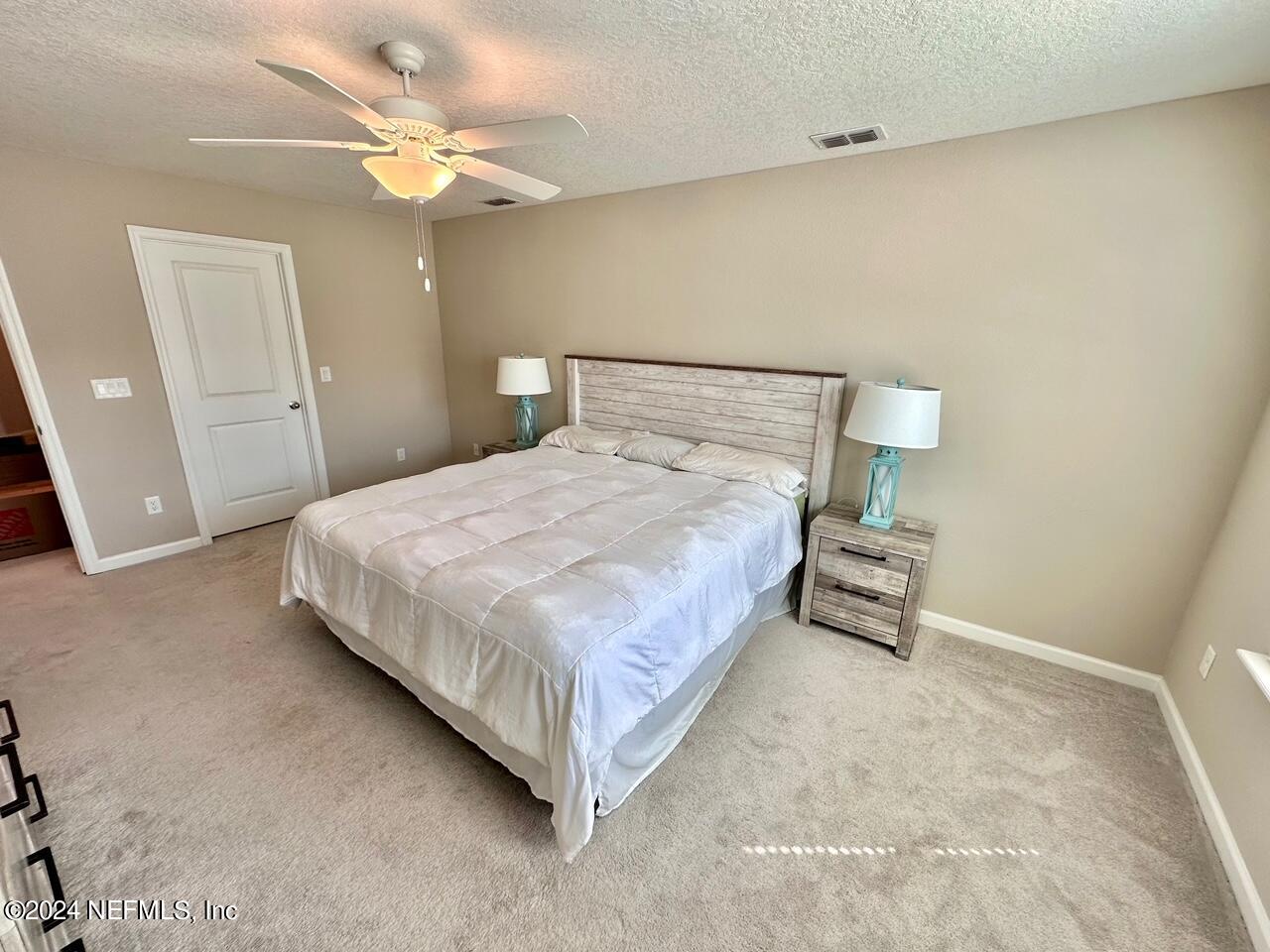 435 Boracay Circle St. Johns, FL 32259 - Photo 16 of 31 a bedroom with a bed and a chandelier