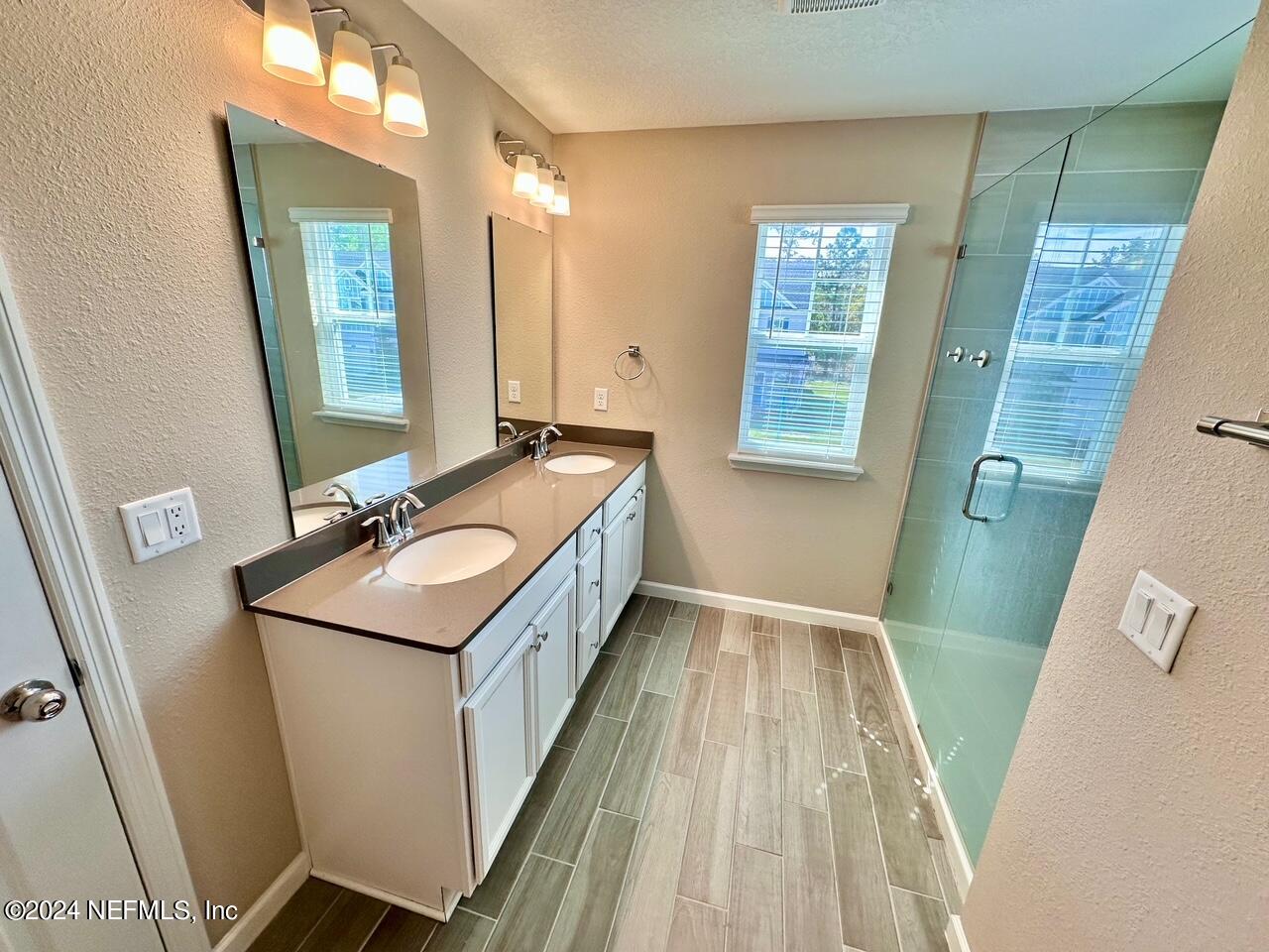435 Boracay Circle St. Johns, FL 32259 - Photo 17 of 31 a bathroom with a sink a toilet and mirror