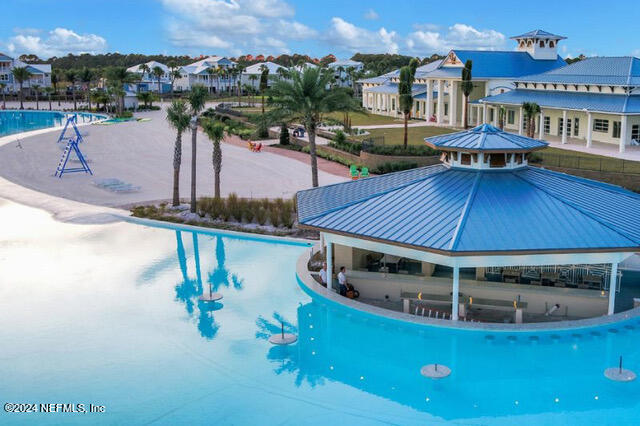 435 Boracay Circle St. Johns, FL 32259 - Photo 21 of 31 a view of a swimming pool with a table and chairs