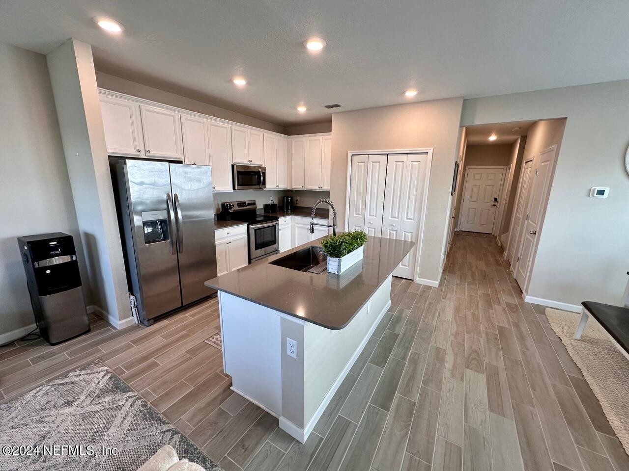435 Boracay Circle St. Johns, FL 32259 - Photo 3 of 31 a kitchen with stainless steel appliances granite countertop a refrigerator a sink a stove and a wooden floors