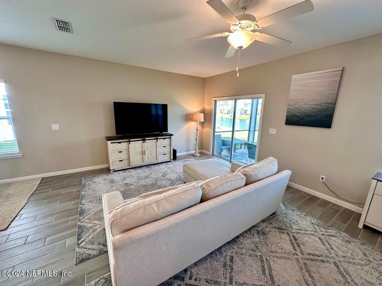 435 Boracay Circle St. Johns, FL 32259 - Photo 7 of 31 a living room with furniture and a flat screen tv