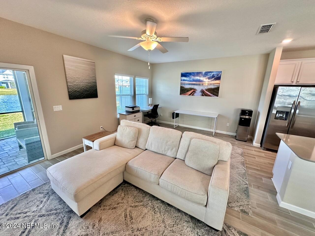 435 Boracay Circle St. Johns, FL 32259 - Photo 9 of 31 a living room with furniture and a flat screen tv