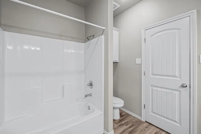 a bathroom with a bathtub and a toilet