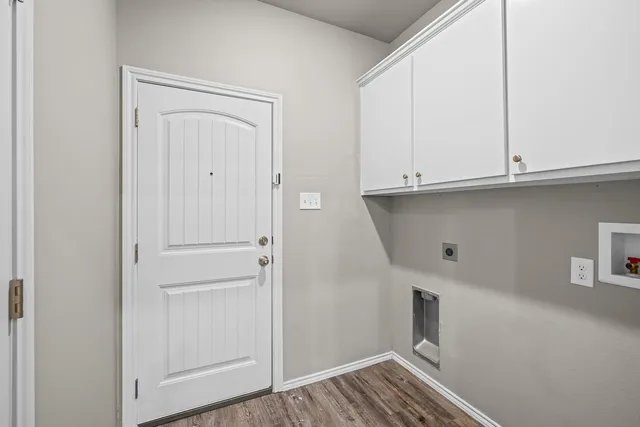 a view of cabinets and utility room with closet