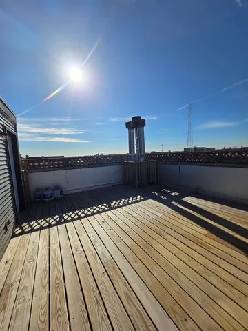 a view of balcony and deck with wooden floor