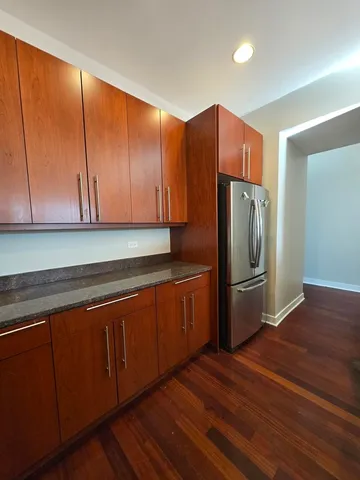 a kitchen with stainless steel appliances granite countertop a refrigerator and a sink