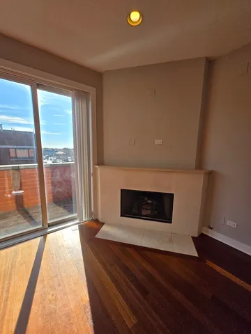 a living room with a fireplace and a floor to ceiling window