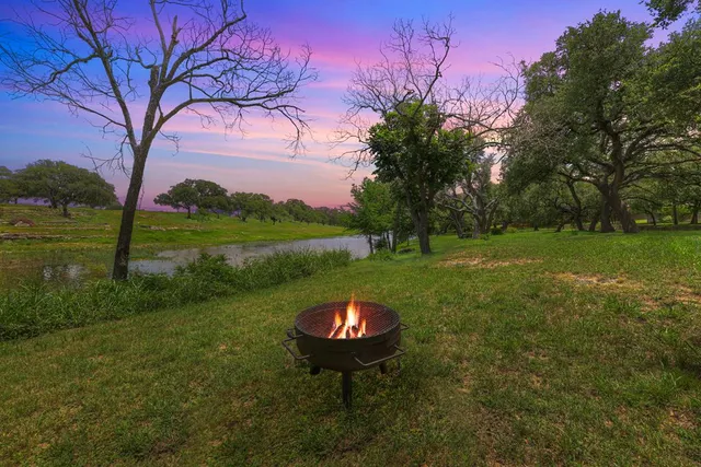 a backyard of a house with table and chairs
