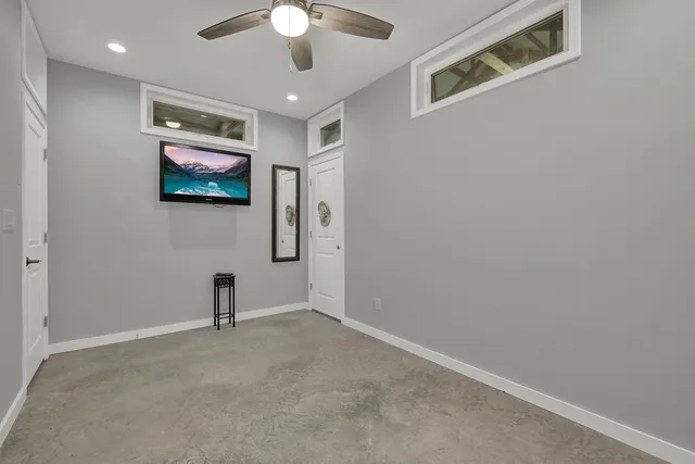 en empty room with projector and fan