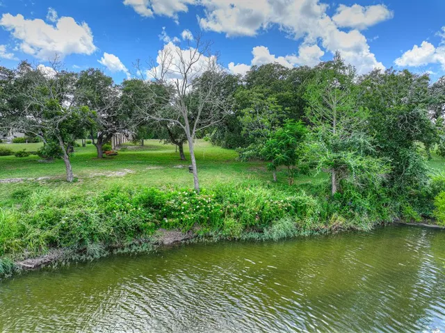 a view of a lake with a house in the background