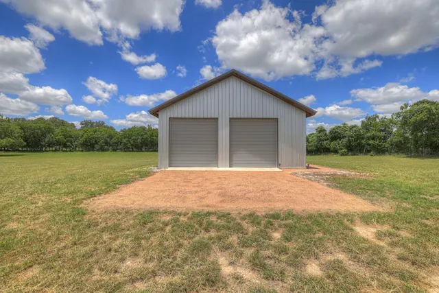 a view of backyard of house with green space