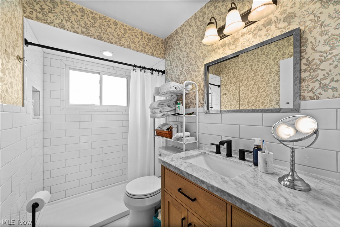 1730 Alcester Road Mayfield Heights, OH 44124 - Photo 16 of 39 Updated bathroom featuring vanity, a shower stall, and tile walls